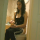 An attractive brunette girl eats a snack while hiccuping, belching, and farting on the toilet at the same time.